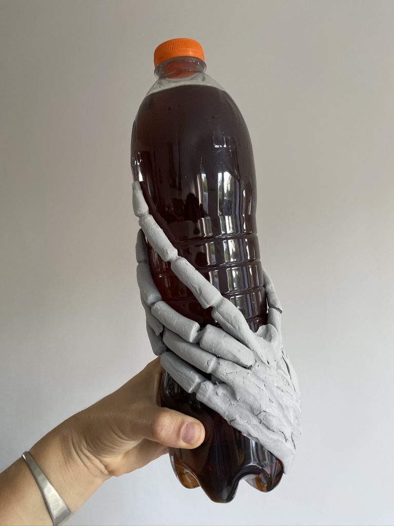 squelette de main sur bouteille