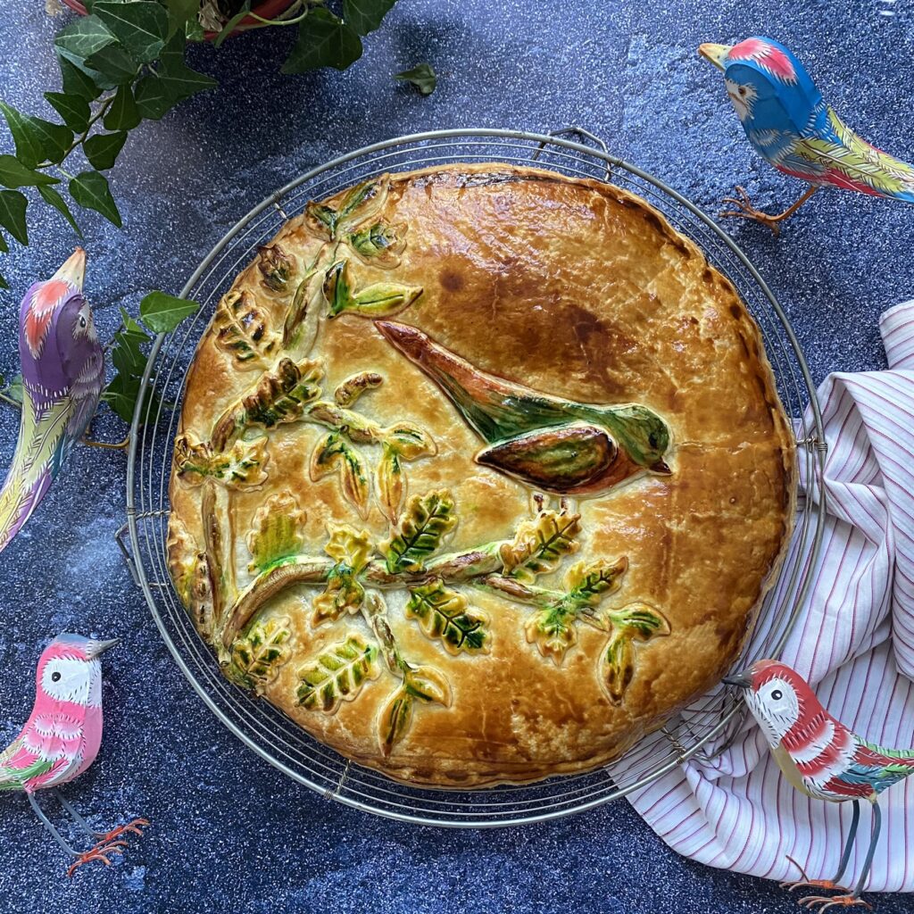 Galette des rois décorée avec un oiseau sur une branche